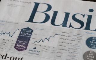 business section of newspaper showing fast growth in a graph