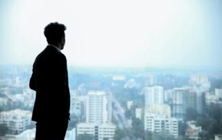 man looking out over city skyline