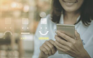 woman smiling with cell phone reflecting happy face